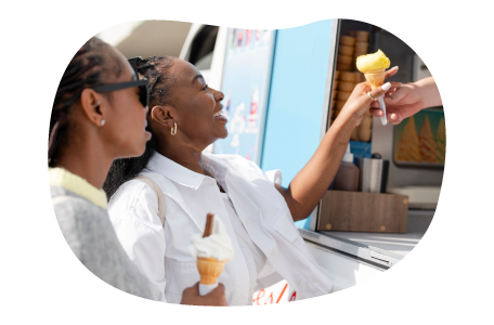 A customer gets an ice cream cone from an ice cream truck. A customer gets an ice cream cone from an ice cream truck.