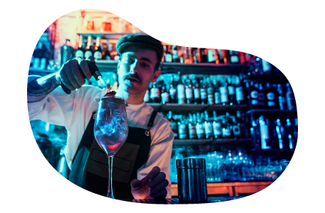 Bartender mixing a drink in a night club.