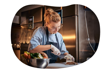 A personal chef slices mushrooms for a dish. A personal chef slices mushrooms for a dish.