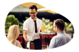 Waiter serving customers a meal in a restaurant.