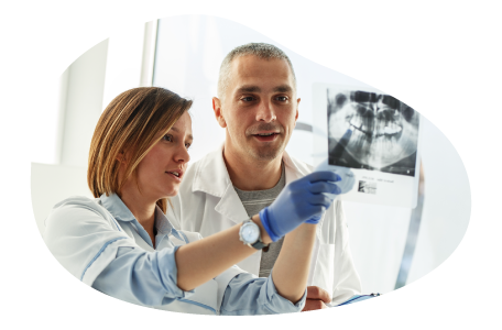 Dental lab technicians reviewing patient x-rays.