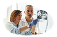 Dental lab technicians reviewing patient x-rays.