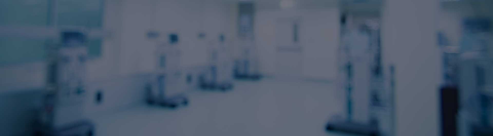 Blurred image of a room filled with dialysis machines.