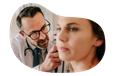 Audiologist examining a patient's ear.