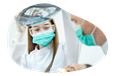 A dental assistant helps a dentist work on a patient.