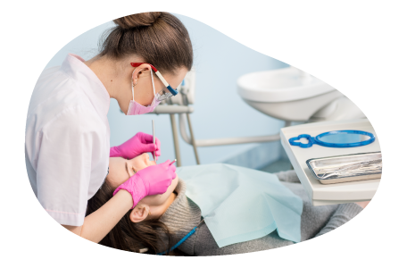 A dental hygienist cleans a patient's teeth. A dental hygienist cleans a patient's teeth.