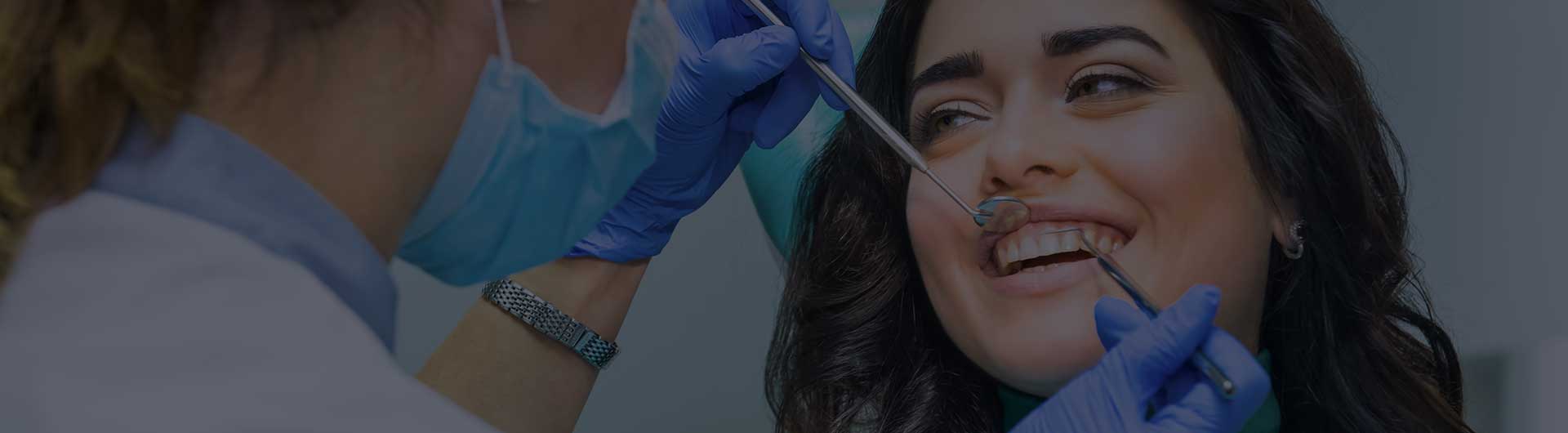 Person smiling during a dental examination. Person smiling during a dental examination.