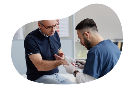 A dermatologist examines the skin on a patient's hand. A dermatologist examines the skin on a patient's hand.