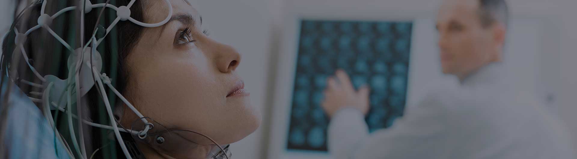 A young woman undergoing electroencephalography. A young woman undergoing electroencephalography.