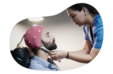 EEG technician preparing a patient for examination.