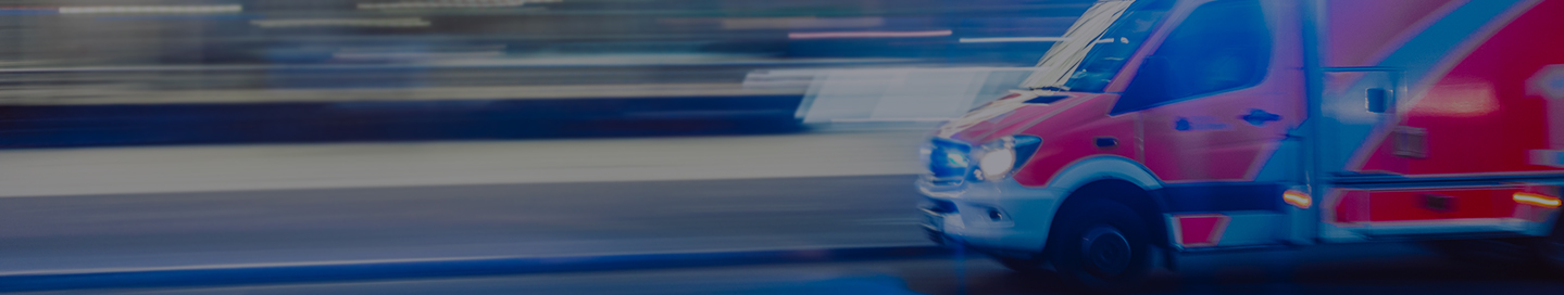 An ambulance speeding down the road.