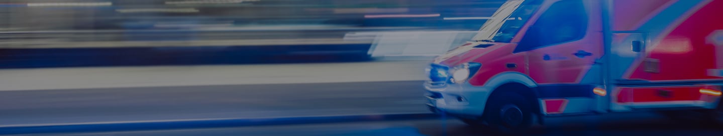 An ambulance speeding down the road. An ambulance speeding down the road.