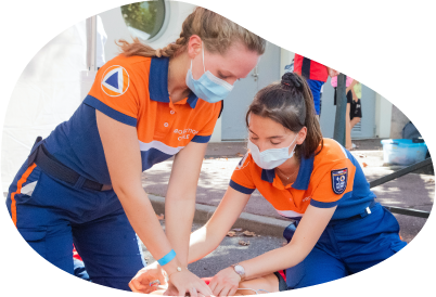 Two EMTs working on a patient together. Two EMTs working on a patient together.