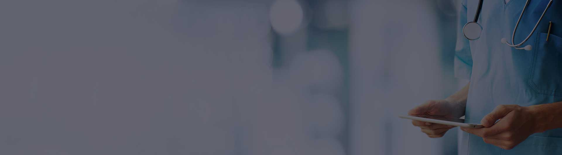 Doctor holding a tablet in a medical office.