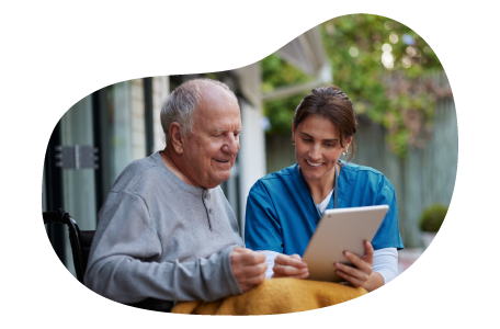 A hospice care nurse helps a patient with a tablet.