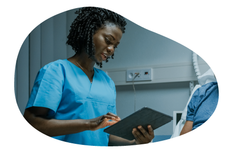 A licensed practical nurse checks a hospital patient's records.