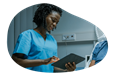 A licensed practical nurse checks a hospital patient's records.