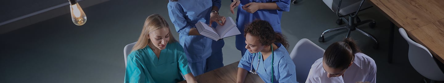 A nurse educator explains a technique to a nursing student. A nurse educator explains a technique to a nursing student.