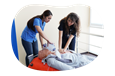 A nurse educator trains a student using a CPR manikin.