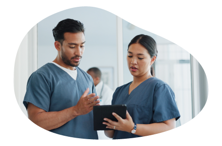 Nurse reviewing a medical chart with a colleague. Nurse reviewing a medical chart with a colleague.