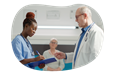 A nursing assistant takes notes from a doctor.