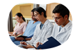 Nursing students taking notes in a classroom.