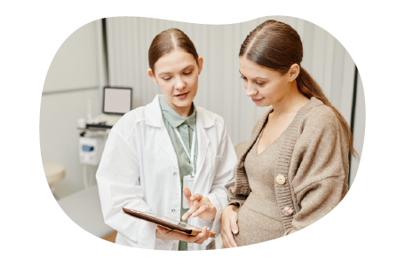 An OB/GYN consults with a pregnant patient. An OB/GYN consults with a pregnant patient.