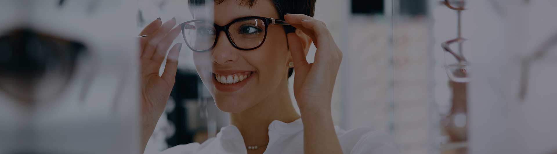 Woman with optician trying eyeglasses. Woman with optician trying eyeglasses.