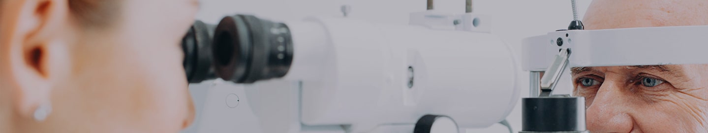 Optometrist checking patient eyesight and vision correction