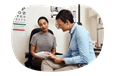 Optometrist reviewing paperwork with a patient.