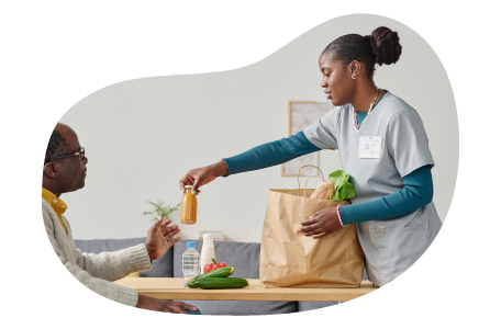 Caregiver providing food for a patient. Caregiver providing food for a patient.