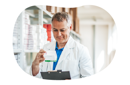 A pharmacist looks over a patient's prescription.