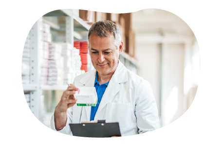 A pharmacist looks over a patient's prescription. A pharmacist looks over a patient's prescription.