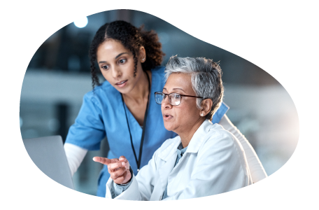 Physician assistant going over research with a physician.