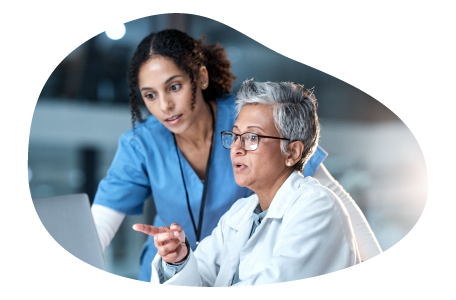 Physician assistant going over research with a physician. Physician assistant going over research with a physician.