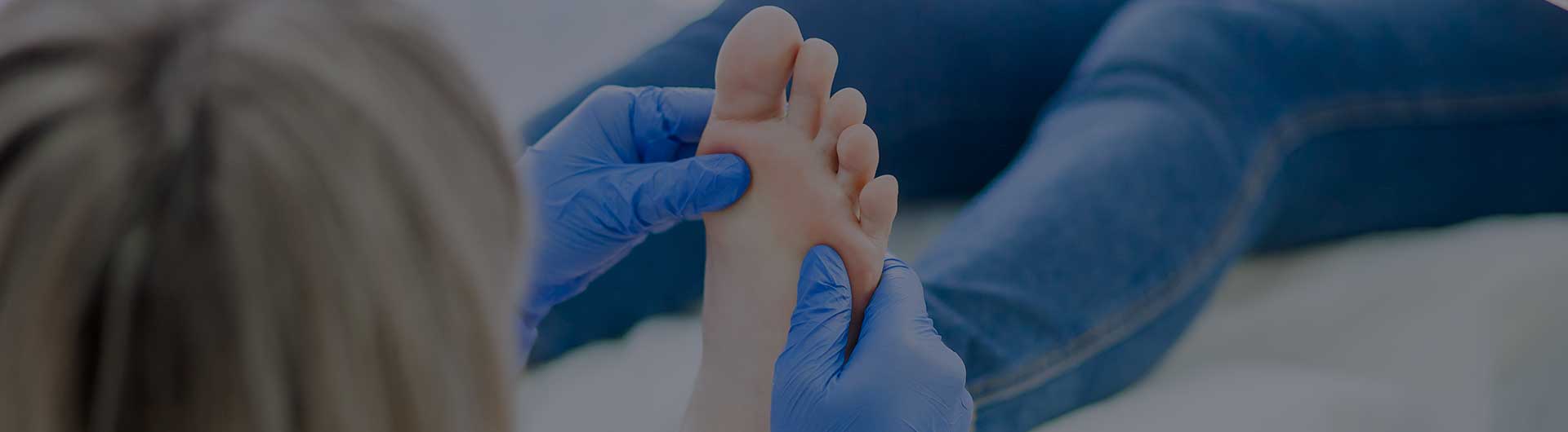 Podiatrist treats foot. Podiatrist treats foot.