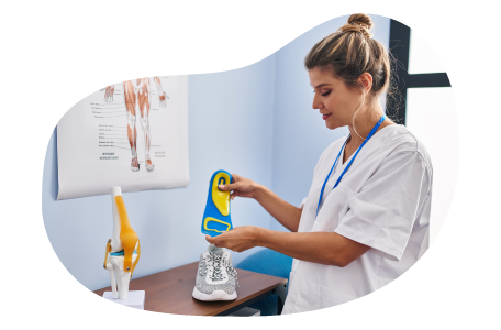 Podiatrist configuring a shoe insert. Podiatrist configuring a shoe insert.