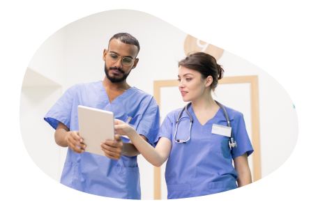 A couple of registered nurses discuss their patients.