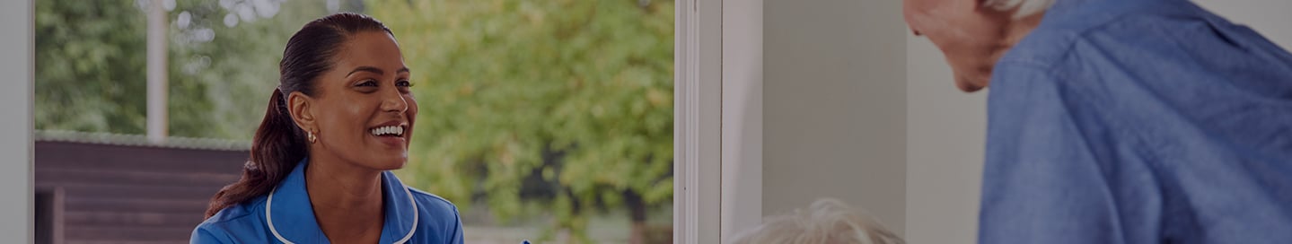 A travel nurse meets an elderly couple for a home visit. A travel nurse meets an elderly couple for a home visit.