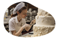 Baker decorating a cake.