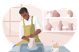 Potter spinning a vase on a pottery wheel.