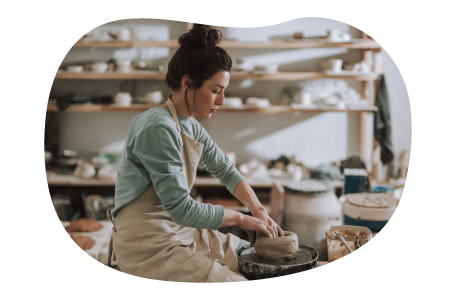 Pottery artisan crafting a clay pot in a shop. Pottery artisan crafting a clay pot in a shop.