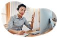 Virtual assistant taking a call from a customer while typing on a laptop.