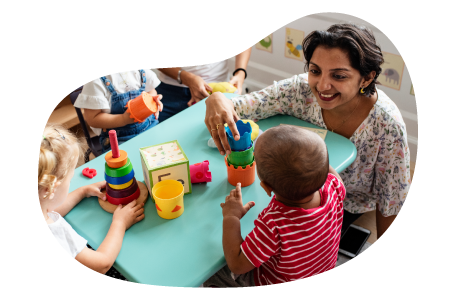 Daycare center employee playing with children.