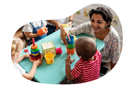Daycare center employee playing with children. Daycare center employee playing with children.