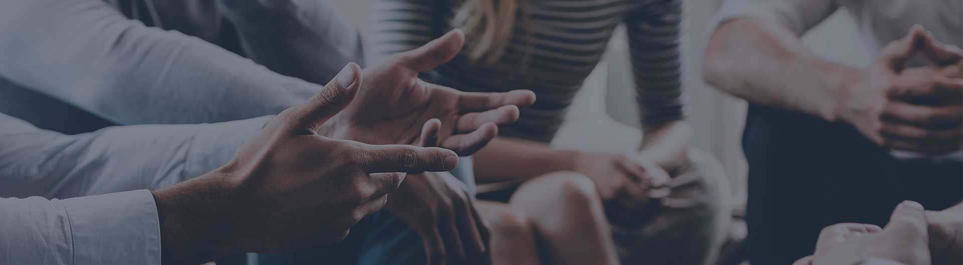 Several people in a circle having a discussion.