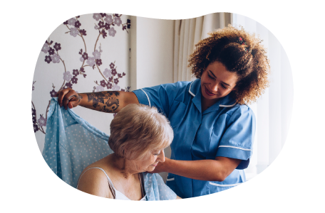 Nursing home employee helping a resident.