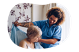 Nursing home employee helping a resident.