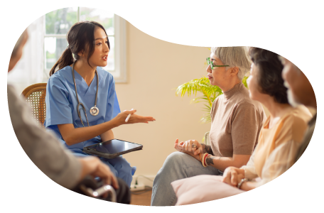 Senior care center employee speaking with residents.