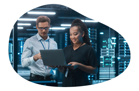 Two employees at a cloud computing company working on a laptop.